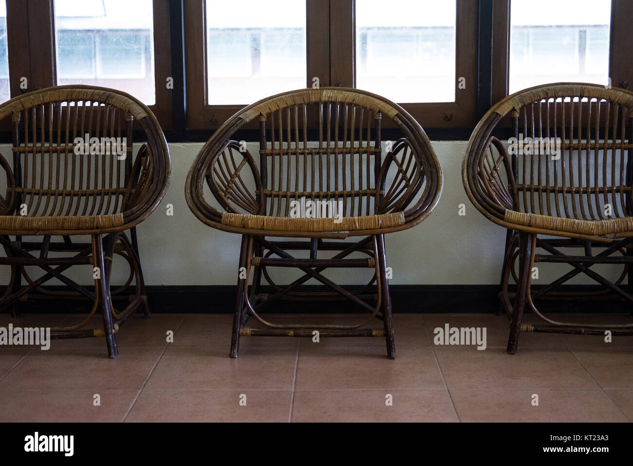 wicker rattan chair in living room beside window Stock Photo Alamy