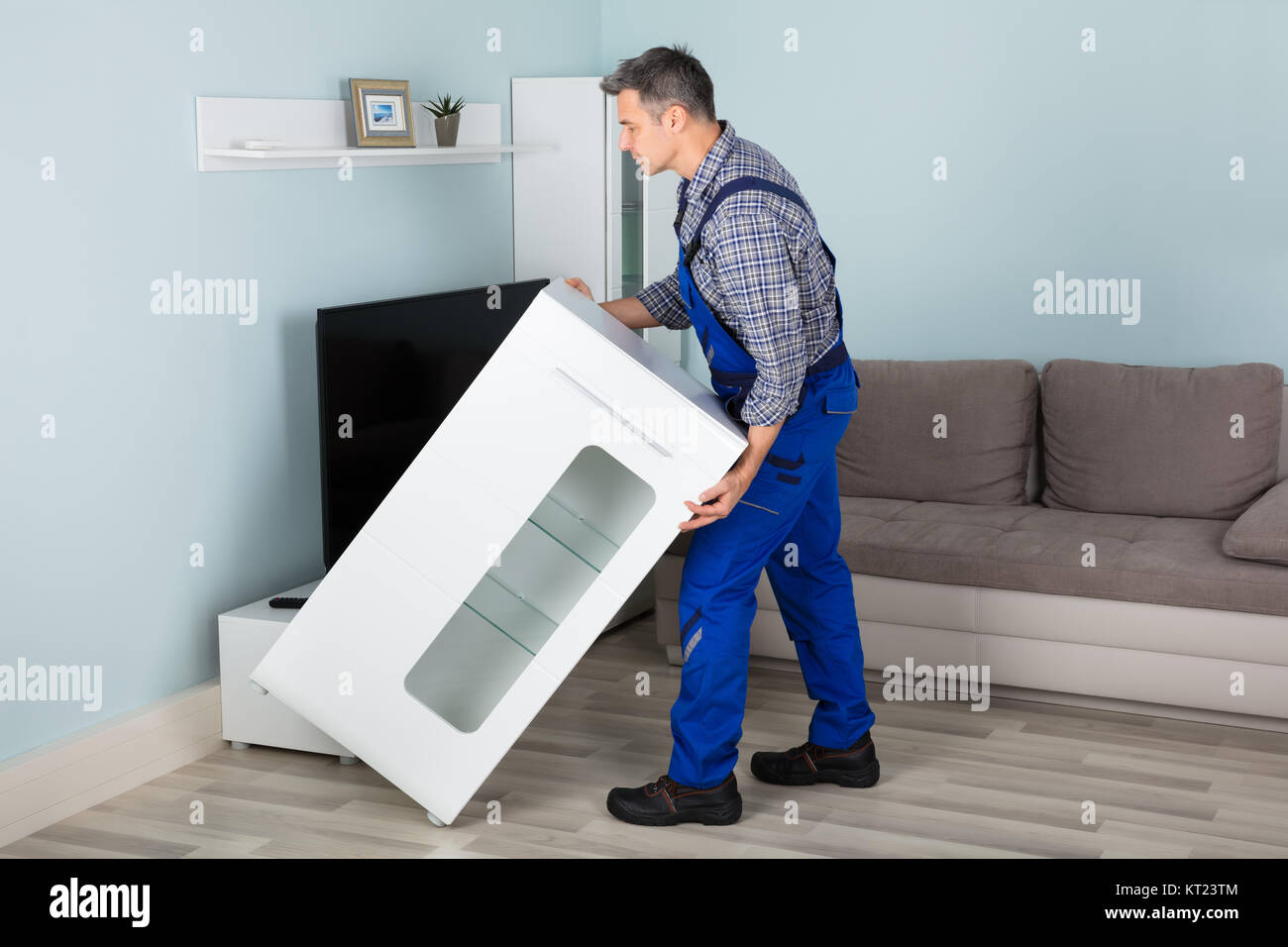 Mover Placing Furniture At Home Stock Photo Alamy
