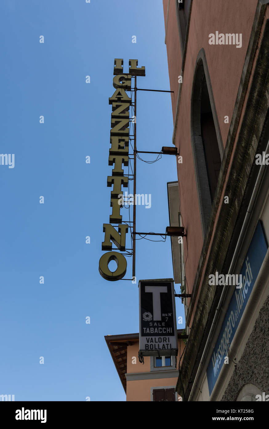 Italian daily local newspaper ‘Il Gazzettino’ sign and traditional blue T tabacchi (tobacconist) sign, Italy Stock Photo