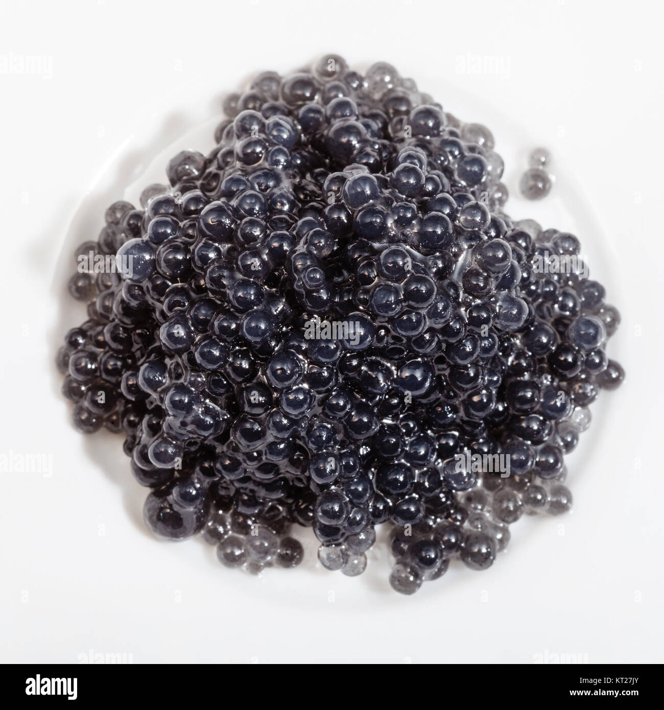 black salty caviare of halibut on white plate Stock Photo