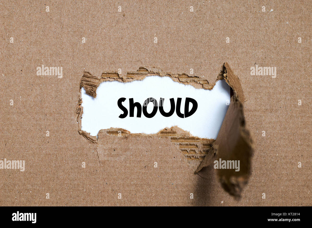 The word should appearing behind torn paper Stock Photo
