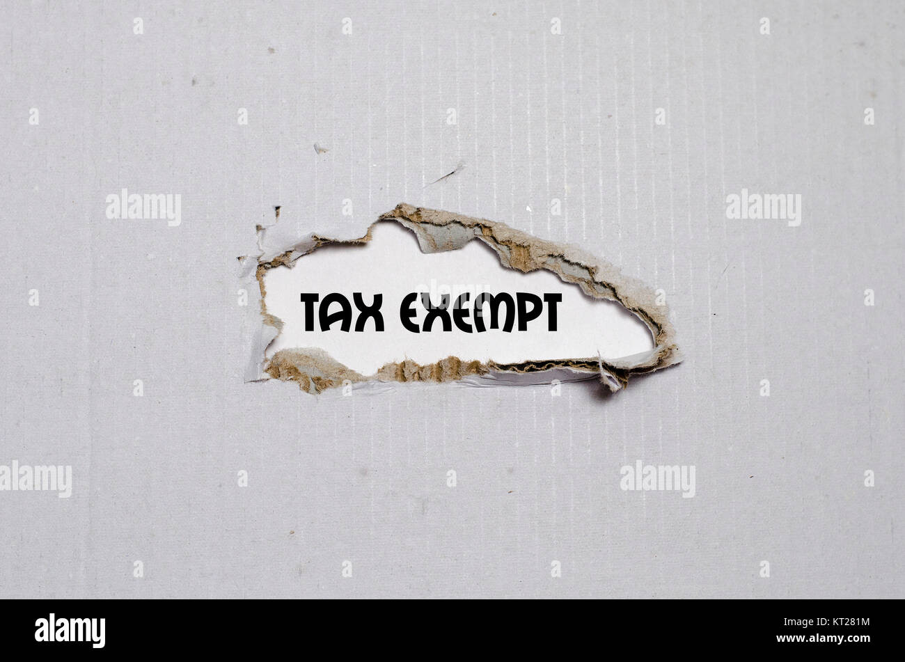 The word tax exempt appearing behind torn paper Stock Photo