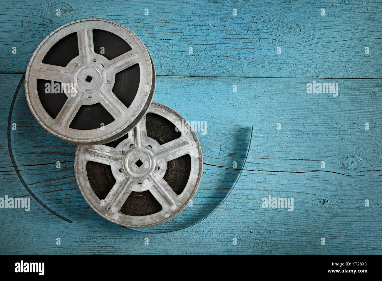 Old film strip on wooden blue background. Top view. Copy space. Stock Photo