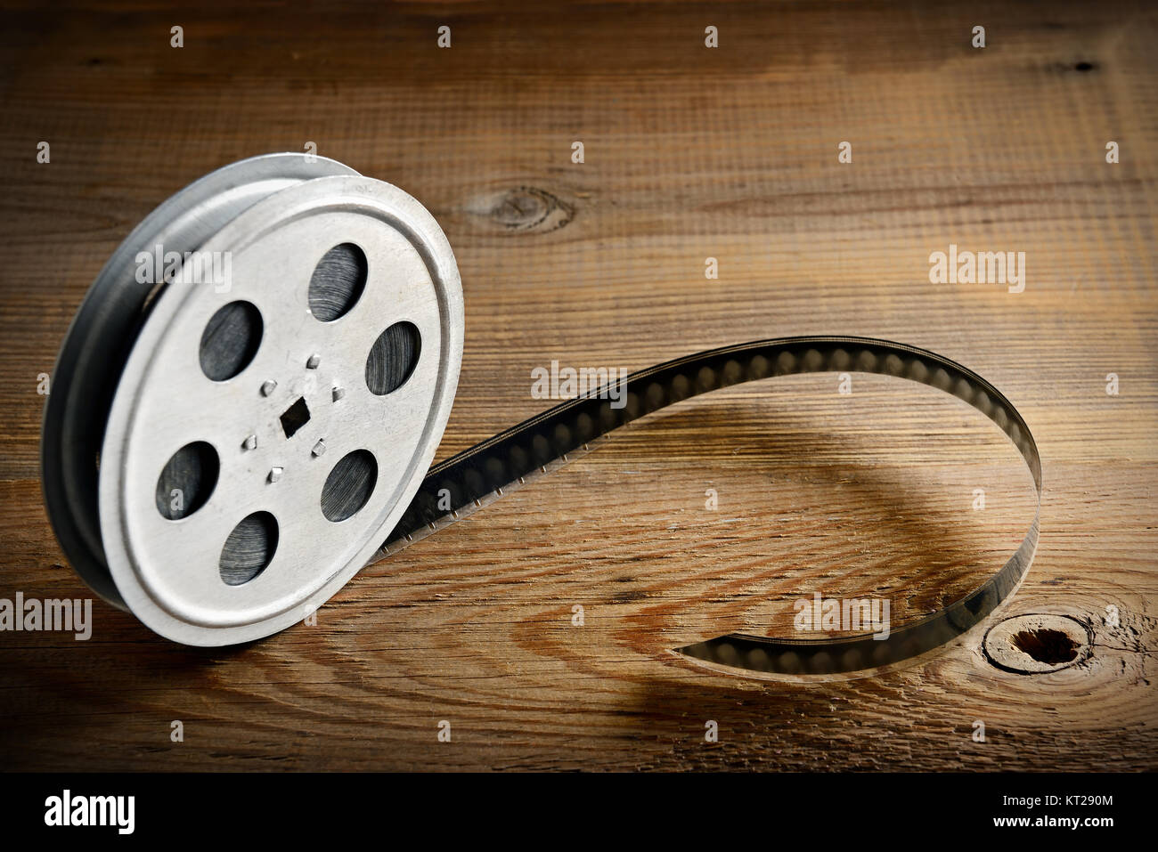 Old film strip on wooden background. Top view. Copy space. Stock Photo