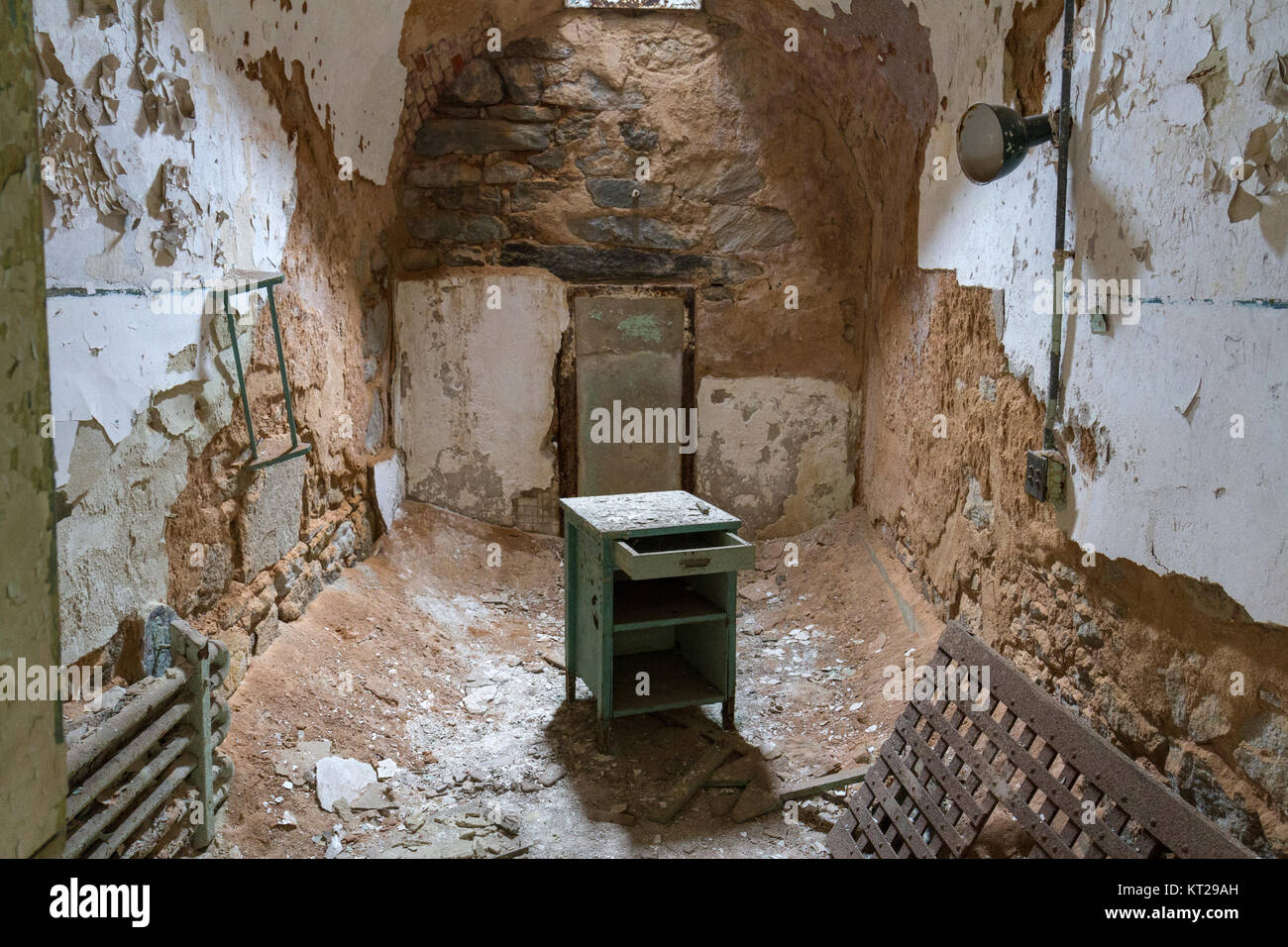 Abandoned prison cell with badly damaged walls in the Eastern State Penitentiary Historic Site, Philadelphia, United States. Stock Photo
