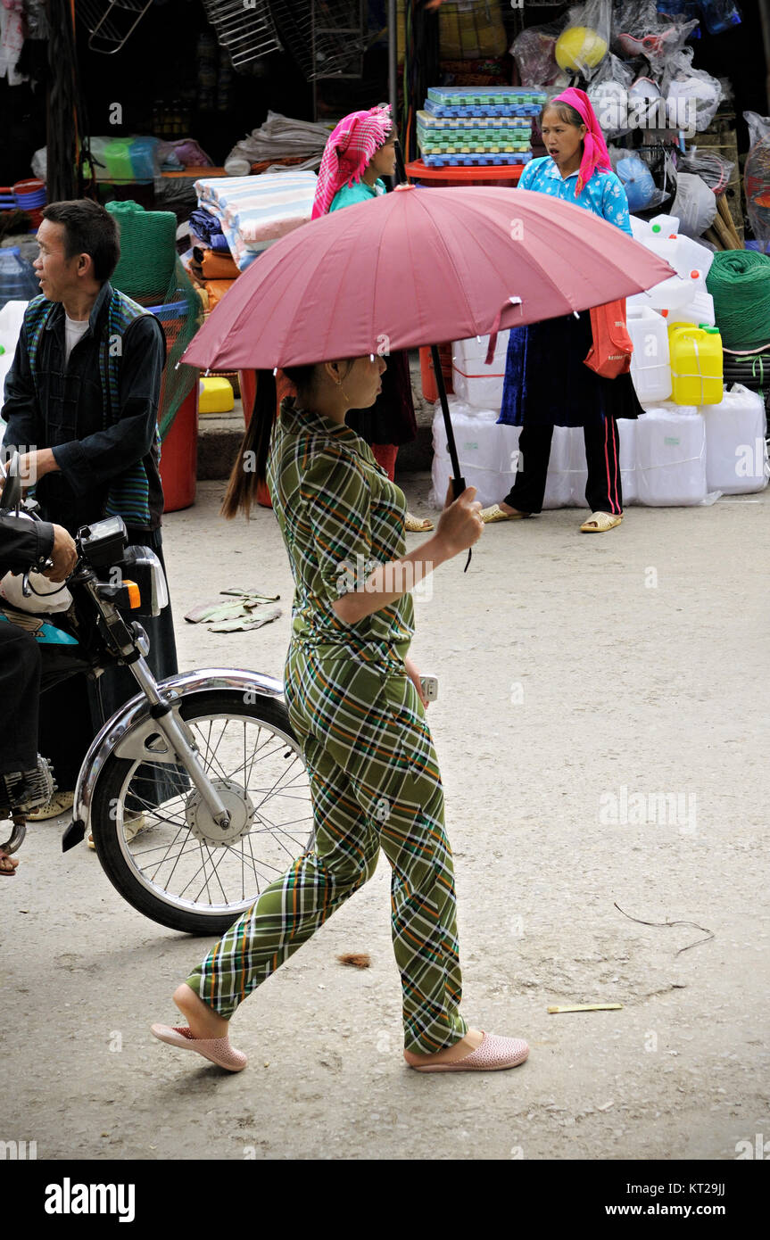 Young woman with an umbrella at the Meo Vac market, Ha Giang province