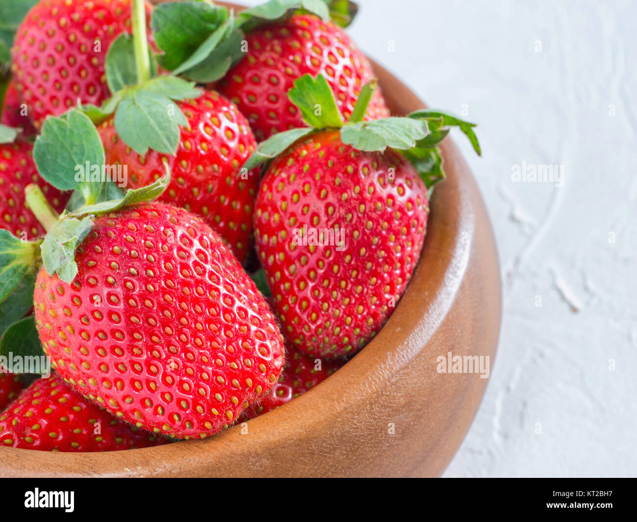 strawberries in wooden bowl Stock Photo - Alamy