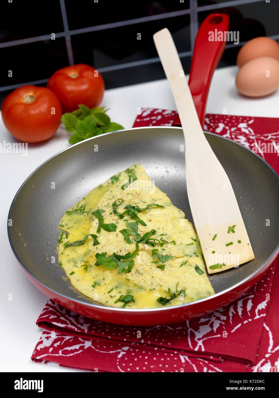 A freshley cooked herb omelette in a frying pan Stock Photo Alamy