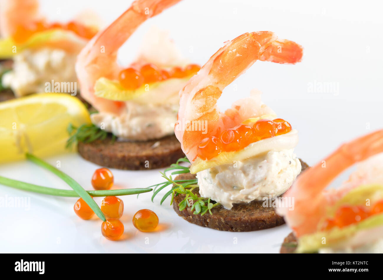 Tidbits with prawns, spiced cream cheese and salmon caviar Stock Photo