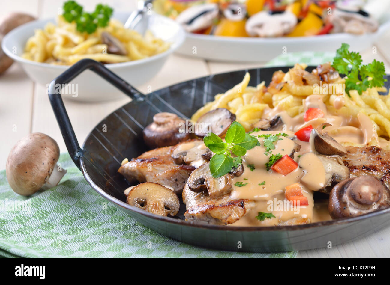 Escalope chasseur with spaetzle and mushrooms served in a frying pan Stock Photo Alamy