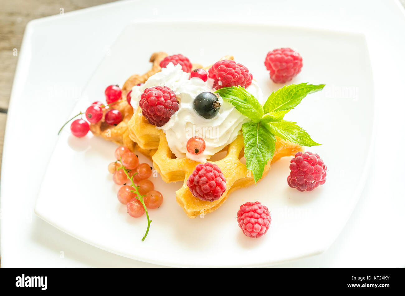 Belgian waffles with whipped cream and fresh berries Stock Photo - Alamy
