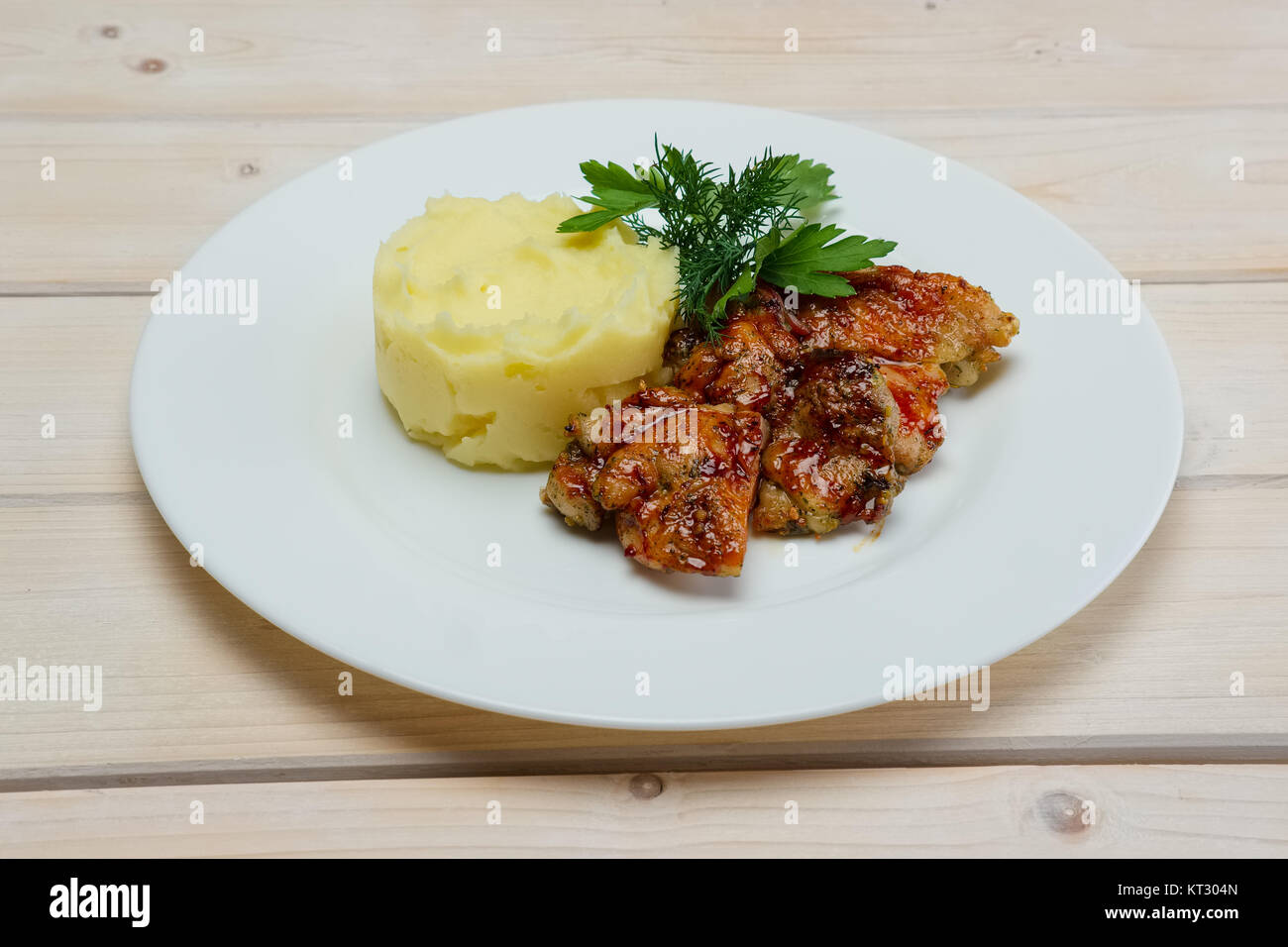 Portion of delicious fried meat in honey sauce with mashed potato Stock Photo