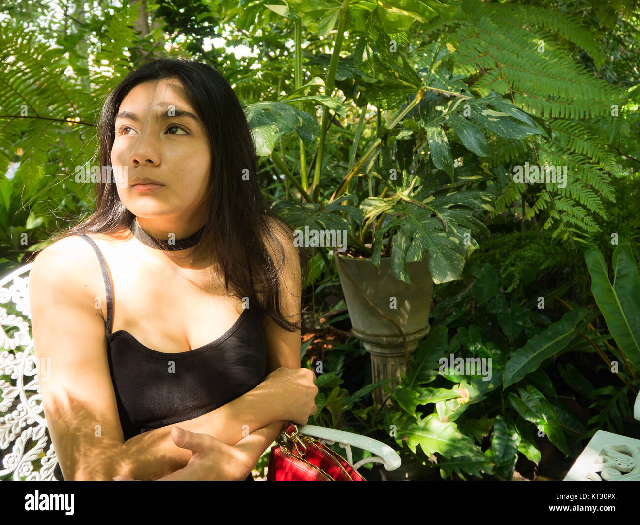 Asian woman sitting on the wooden chair in the garden Stock Photo Alamy