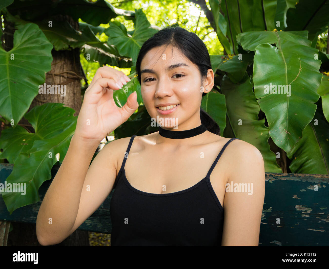 Asian woman sitting on the wooden chair in the garden Stock Photo Alamy