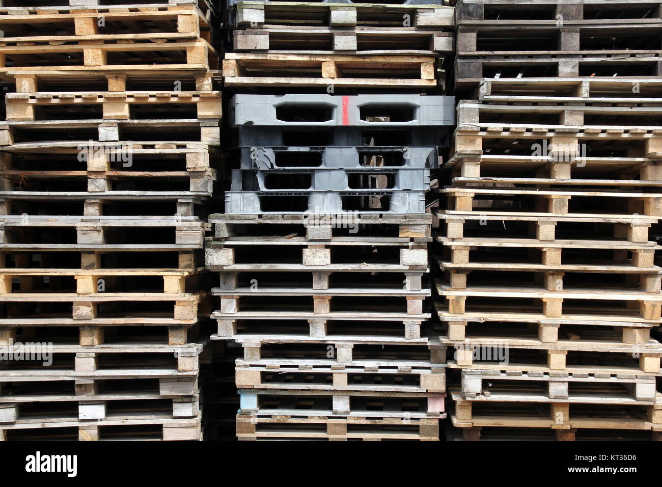 stacked wooden and plastic pallets Stock Photo