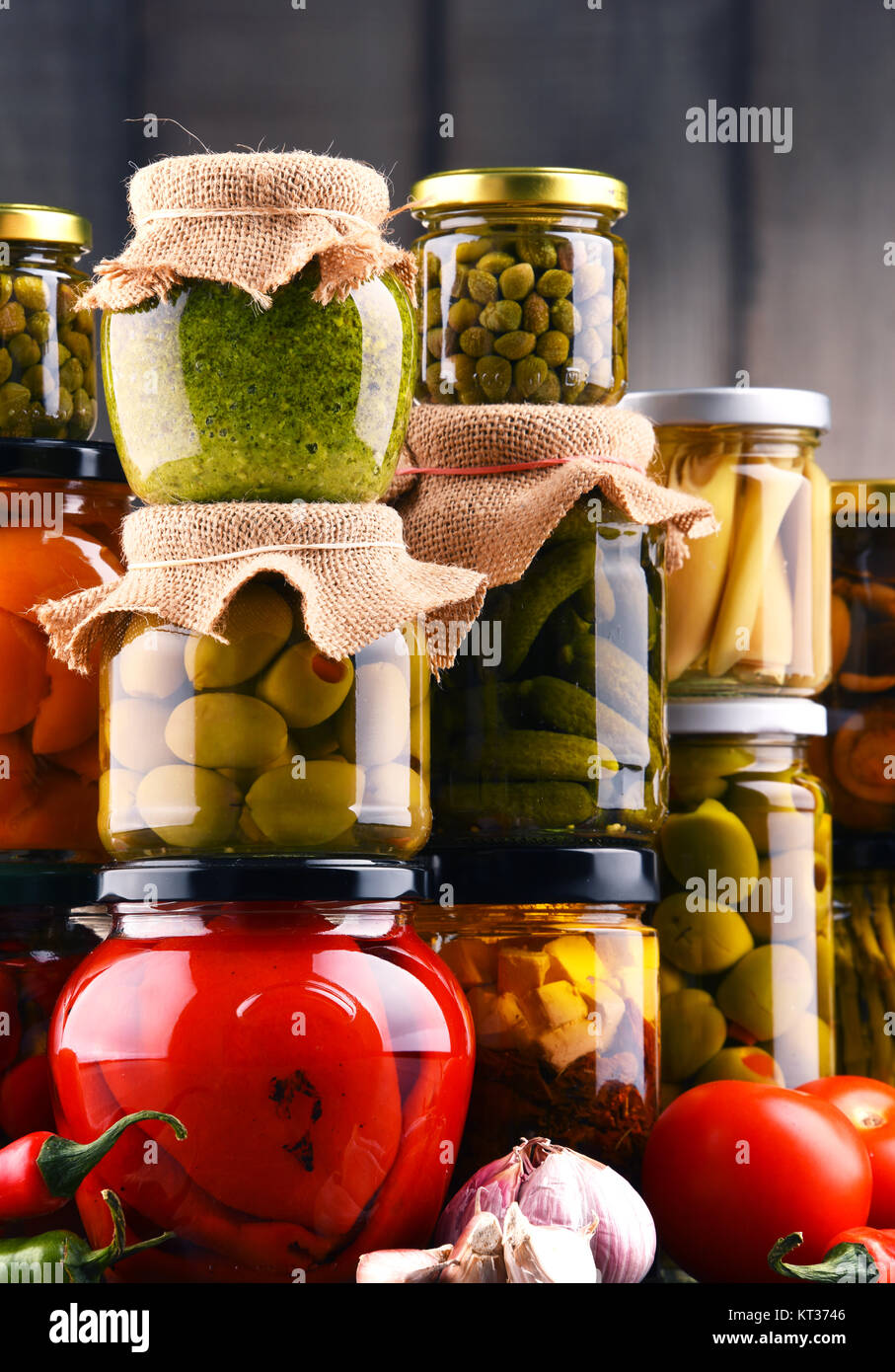 Jars with variety of pickled vegetables. Stock Photo