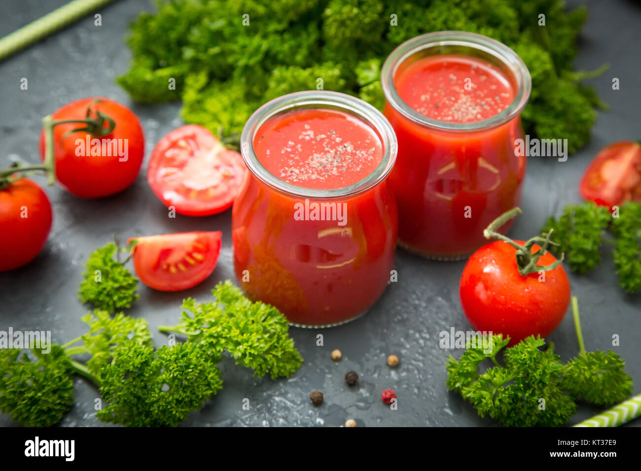 fresh organic tomatoes and tomato juice with parsley. the detox concept