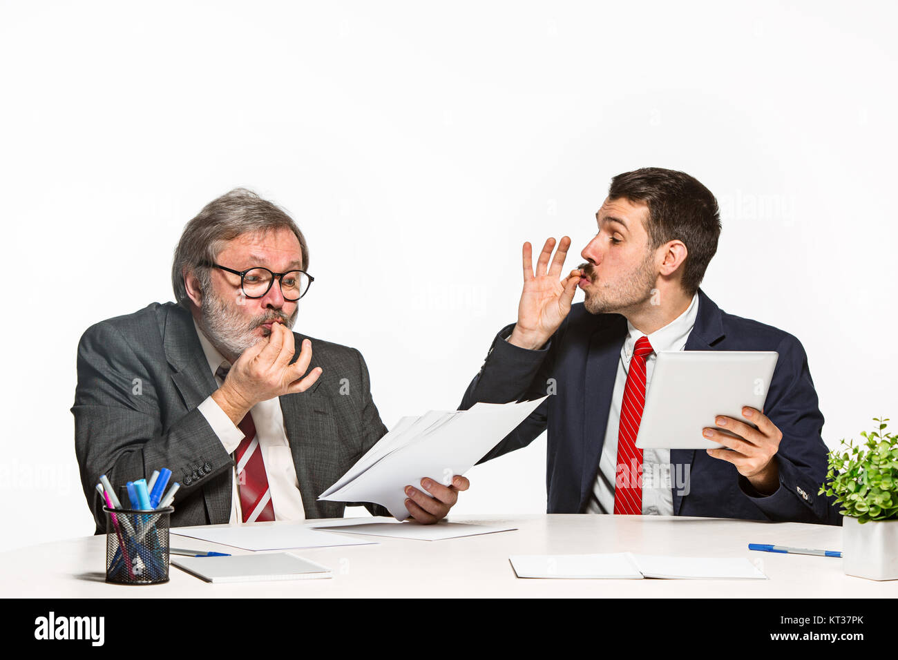 Two Team Members The two colleagues working together at office on white background Stock ...
