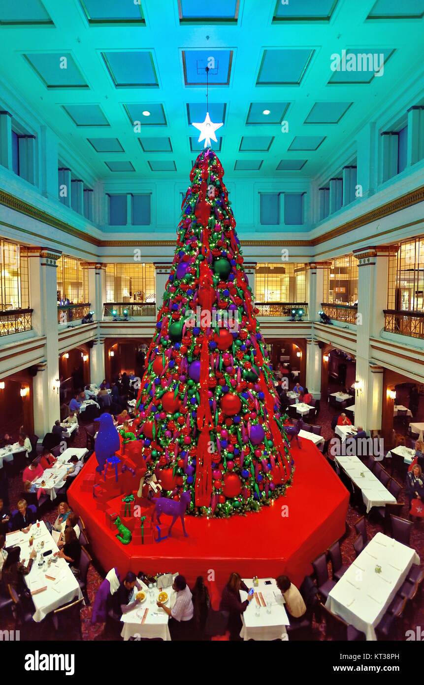 The colorfully decorated Christmas tree in the Walnut Room at Macy's on State Street in Chicago, Illinois, USA. Stock Photo