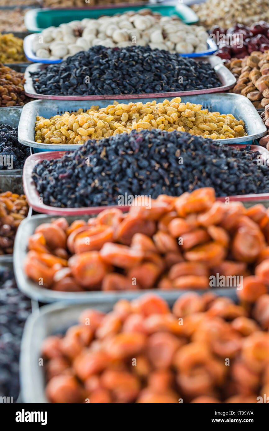 Dry fruits and spices like cashews, raisins, cloves, anise, etc. on display for sale in a bazaar in Osh Kyrgyzstan. Stock Photo