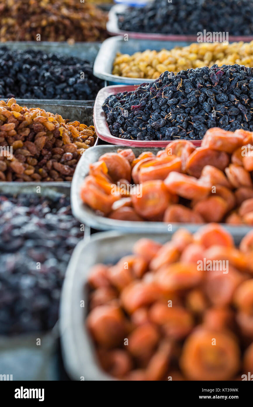 Dry fruits and spices like cashews, raisins, cloves, anise, etc. on display for sale in a bazaar in Osh Kyrgyzstan. Stock Photo
