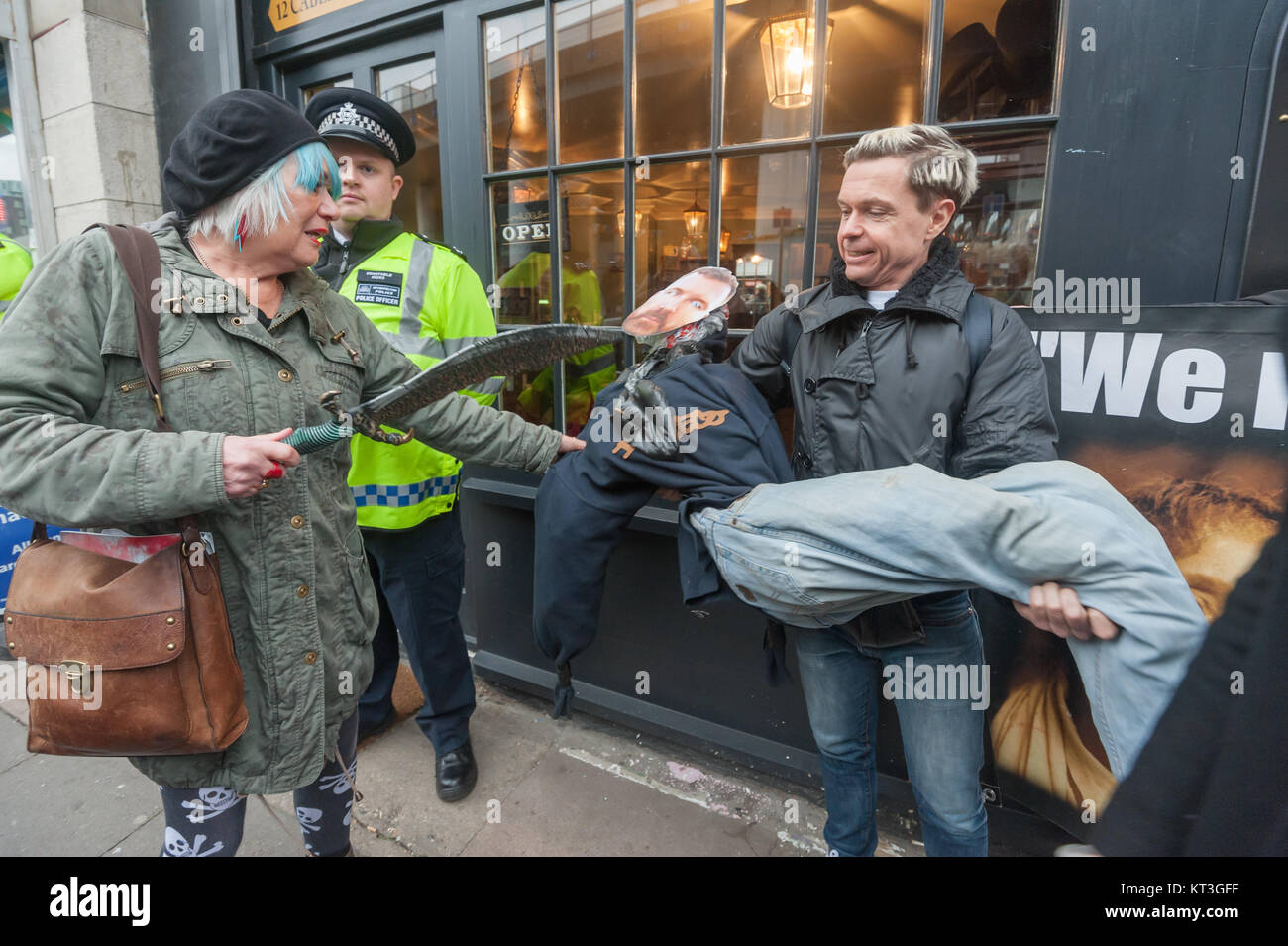 Jane Nicholl of Class War grabs the dummy with a Mark Palmer-Edgecumbe mask and threatens it with her plastic scimitar. Stock Photo