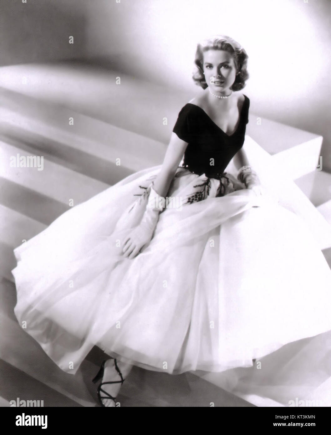 This promotional photograph features Grace Kelly in the 1954 film Rear Window, directed by Alfred Hitchcock. Kelly stars as Lisa Fremont, a fashion model, in a suspenseful thriller about voyeurism and mystery, alongside James Stewart. Stock Photo