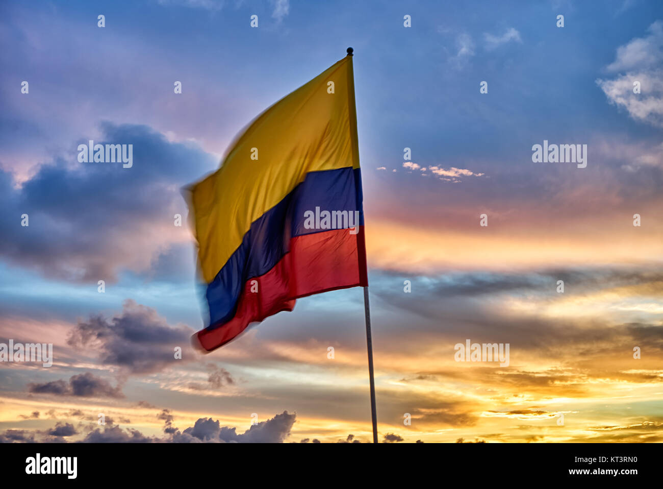 waving Colombian flag again sunset sky Stock Photo