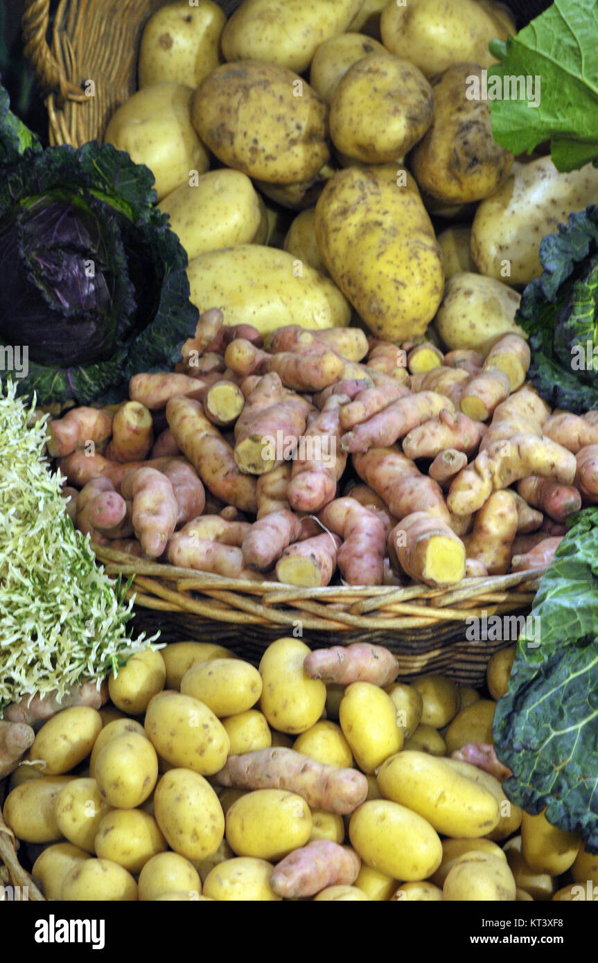 various potato varieties displayed on a colourful stall at borough market in Southwark, London. Spuds and potatoes both new and old varieties for sale Stock Photo