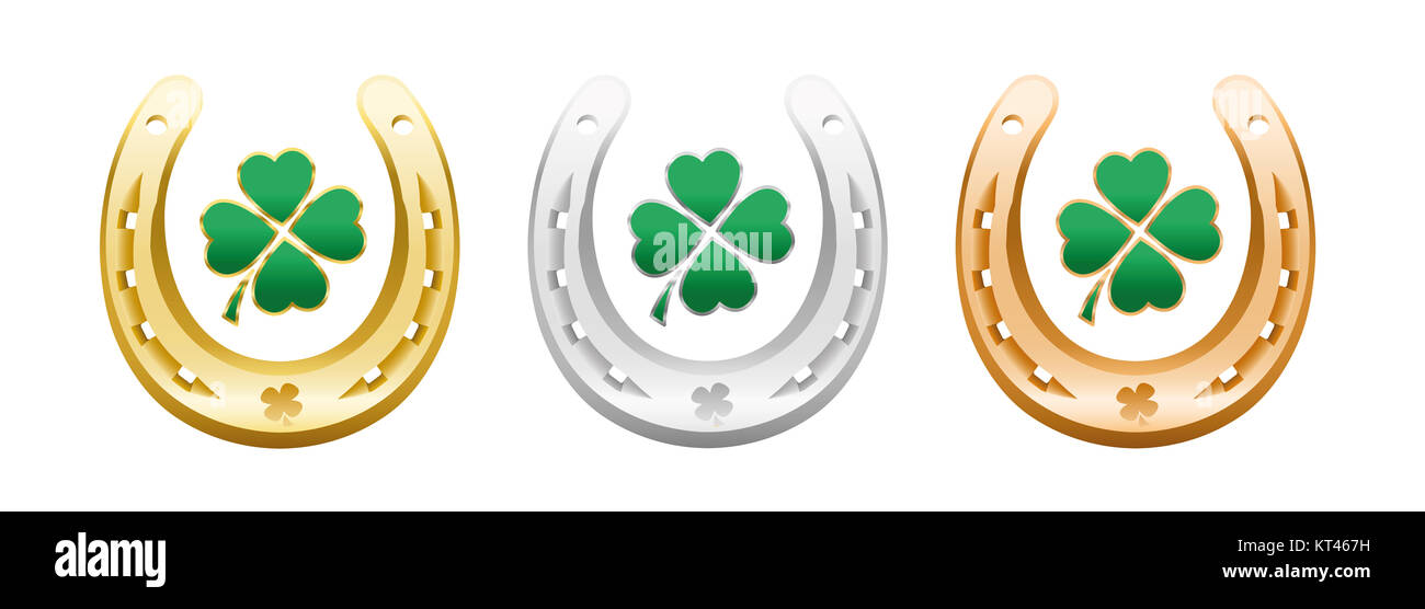 Four leaf clovers in golden, silver and bronze horseshoes - lucky symbols representing success, health, wealth, fortune, luck, happiness. Stock Photo