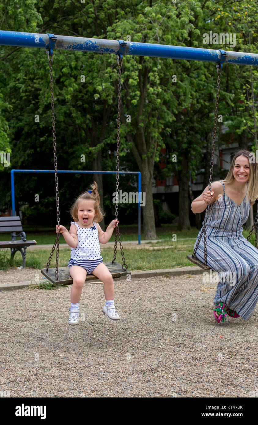 happy cute little girl at playground swinging Stock Photo - Alamy