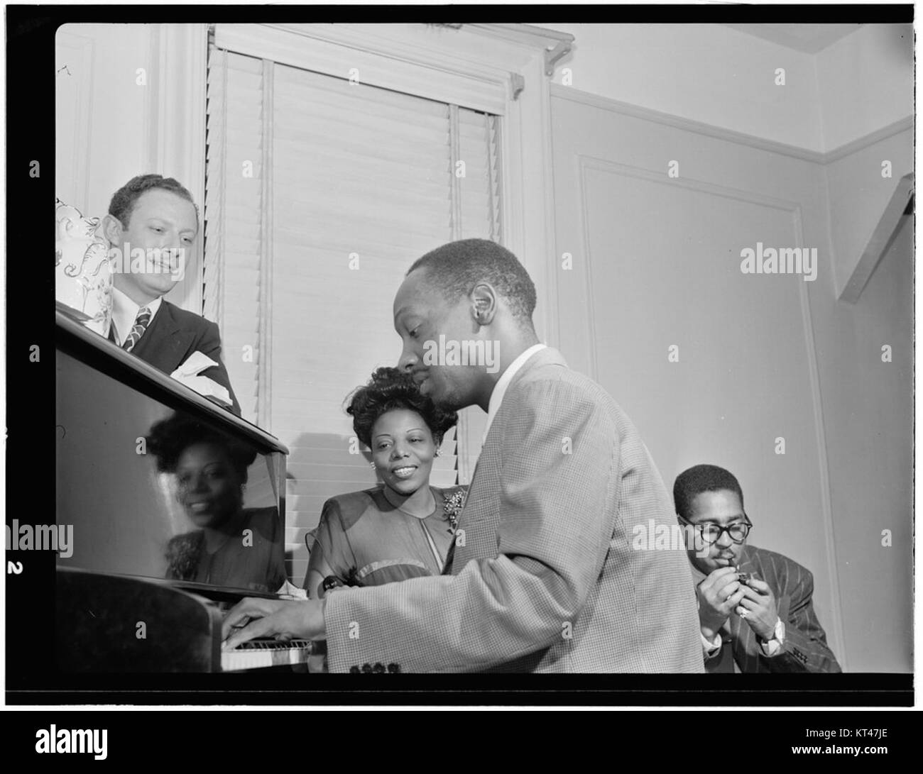 Milt Orent, Mary Lou Williams, Tadd Dameron, and Dizzy Gillespie, Mary Lou Williams' apartment, New York, ca. Aug. 1947 (William P. Gottlieb 15921) Stock Photo