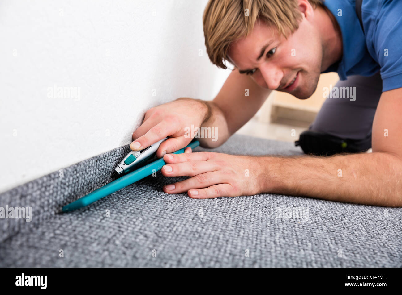 Craftsman Cutting Carpet With Cutter Stock Photo Alamy