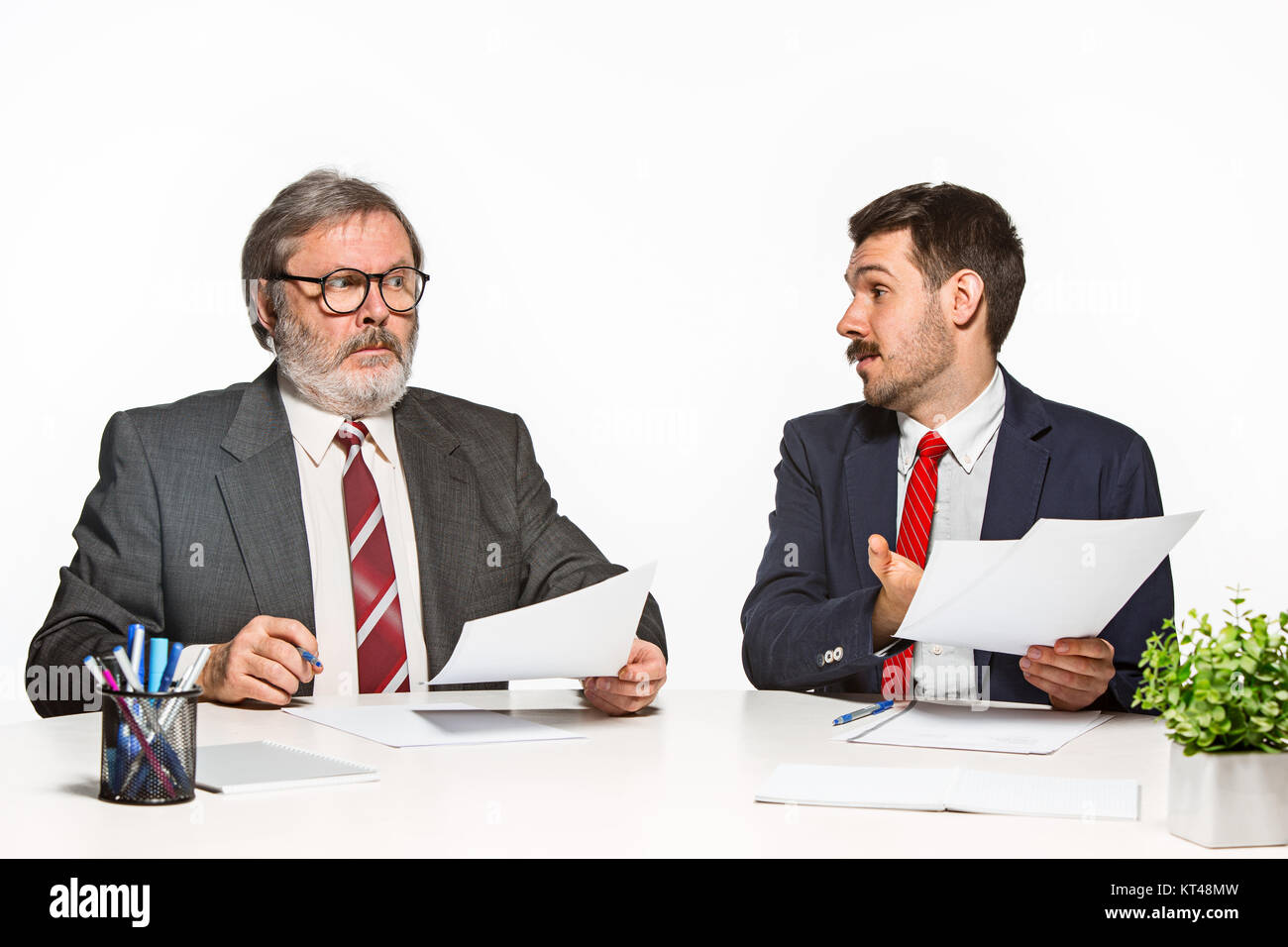 Two Team Members The two colleagues working together at office on white background Stock ...