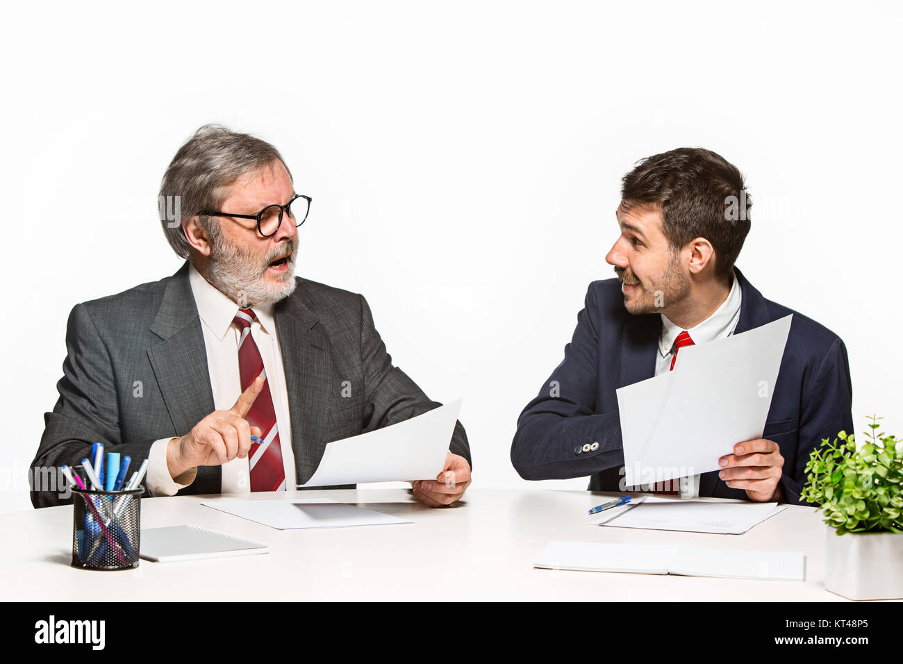 Two Team Members The two colleagues working together at office on white background Stock ...