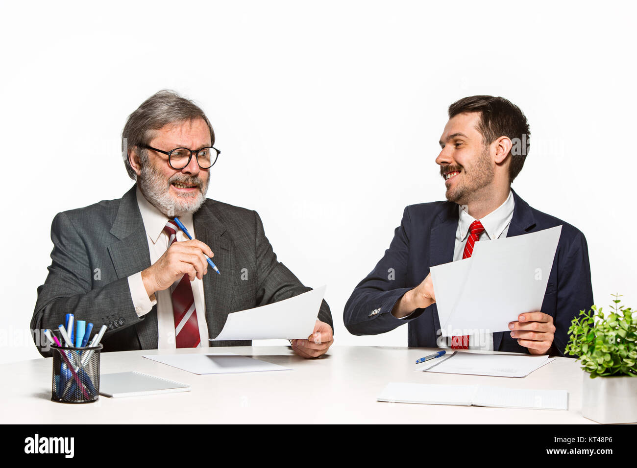 Two Team Members The two colleagues working together at office on white background Stock ...