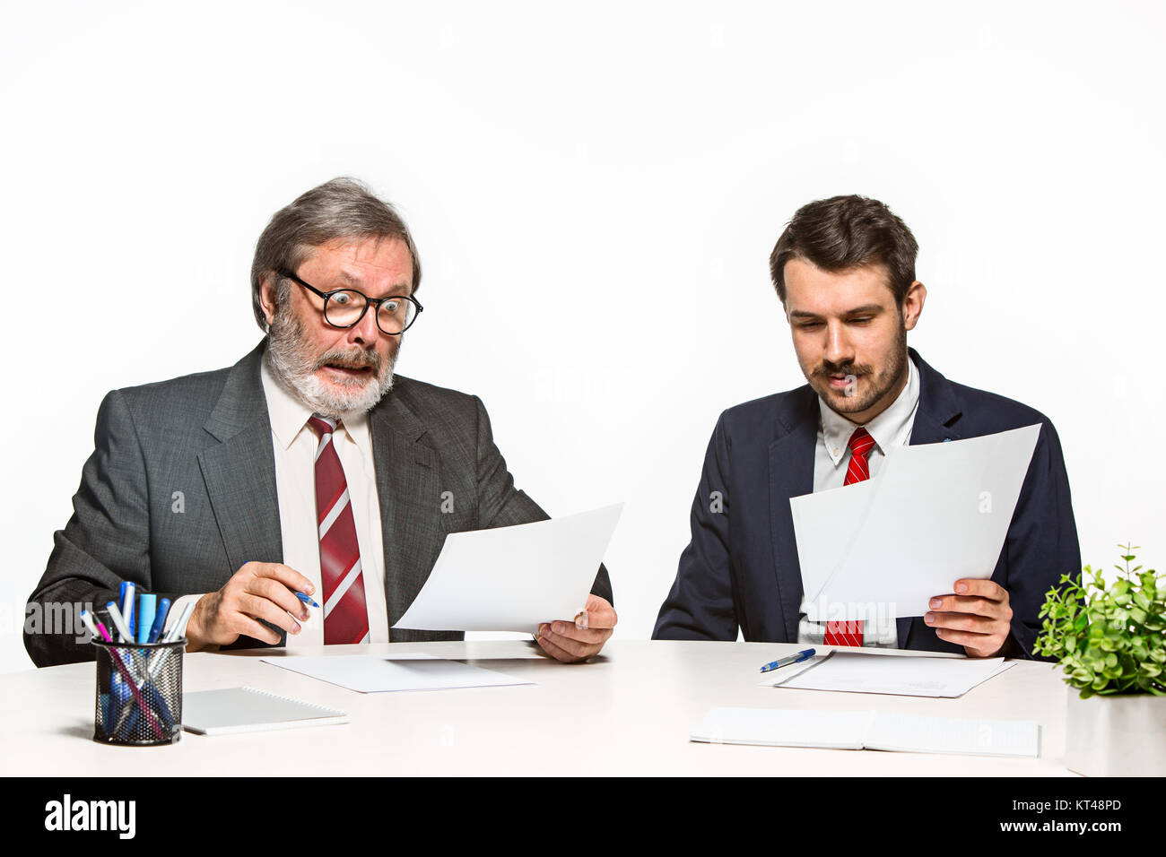 Two Team Members The two colleagues working together at office on white background Stock ...