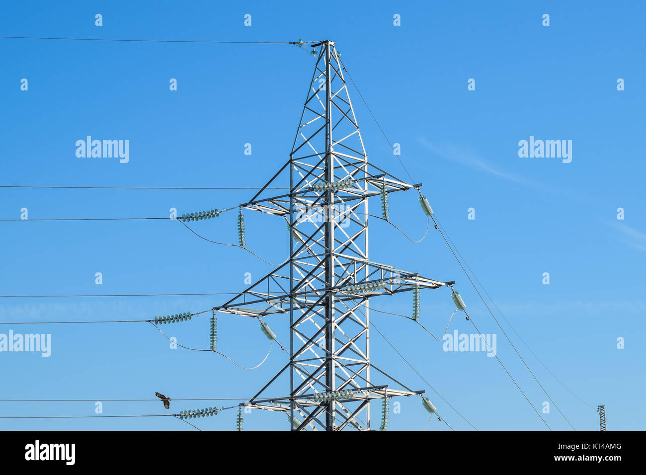 Supports high-voltage power lines against the blue sky Stock Photo - Alamy