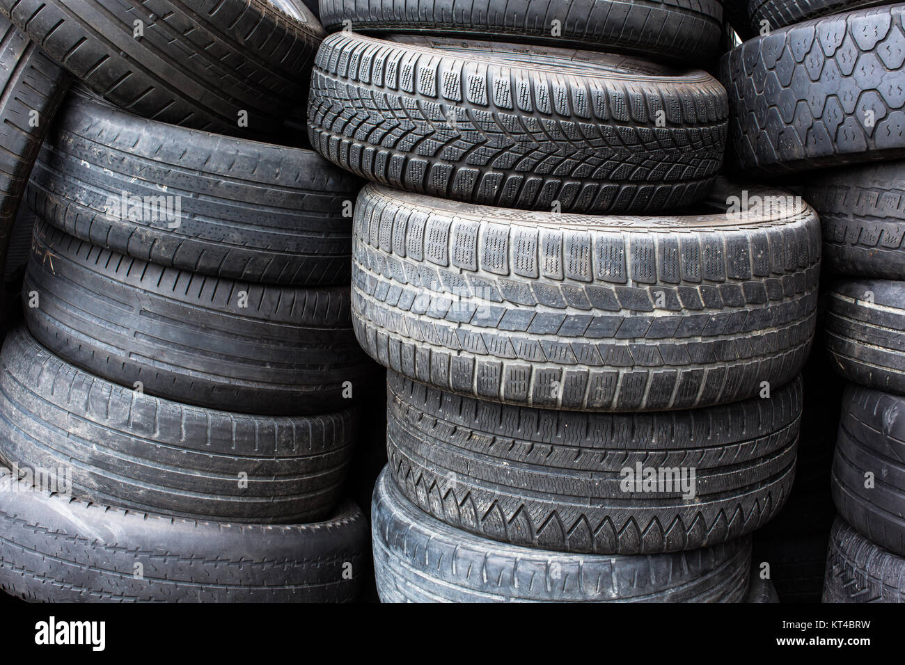 Tires for sale at a tire store - stacks of old used tires Stock Photo