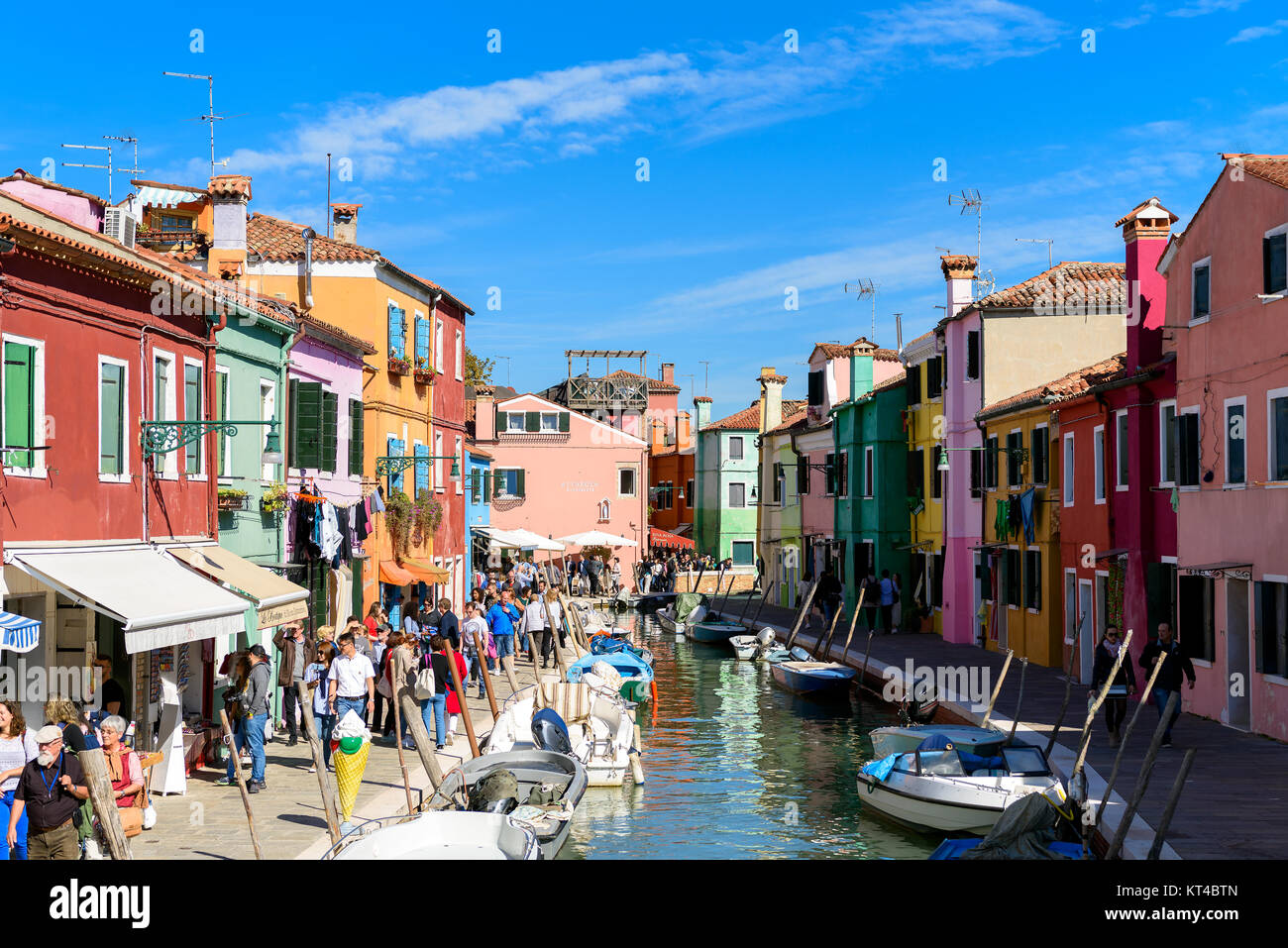 Tourists and colorful houses along the canal on the Venetian island of Burano, Venice lagoon, Italy Stock Photo