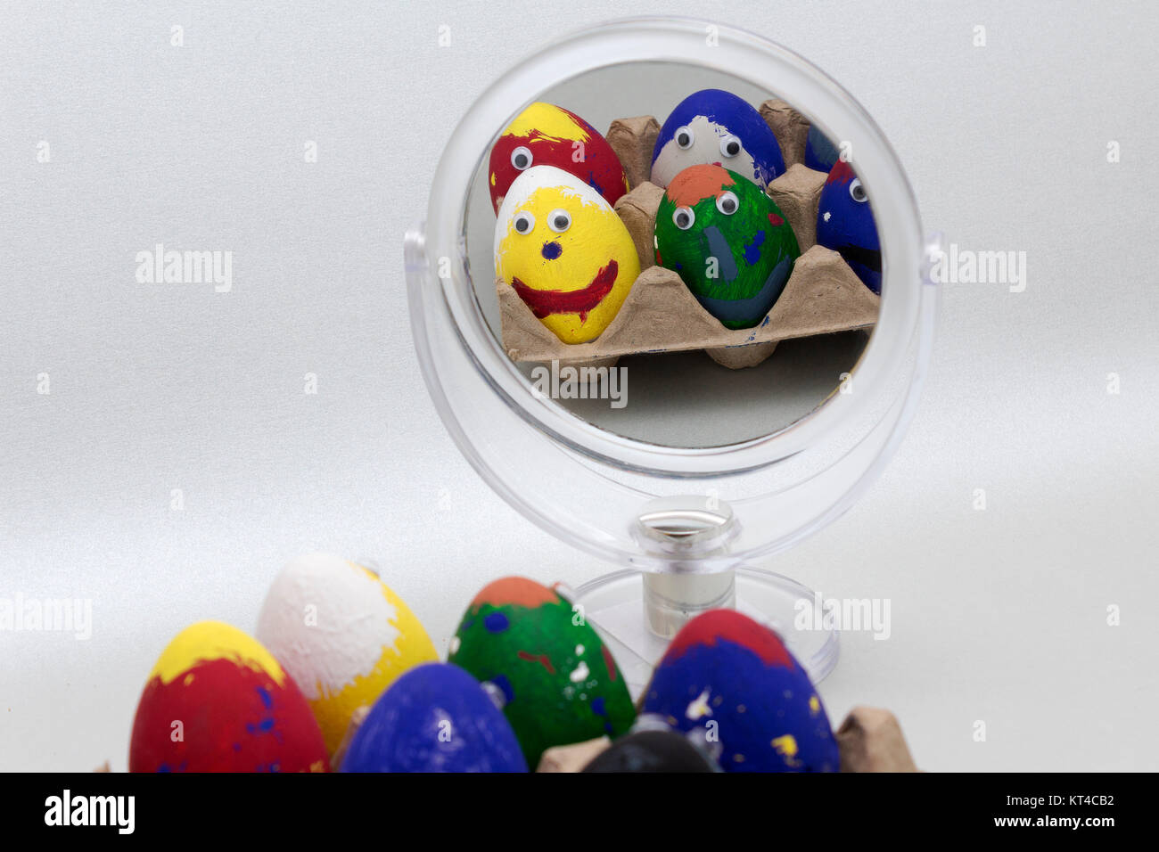 reflection of painted eggs in a table mirror Stock Photo Alamy