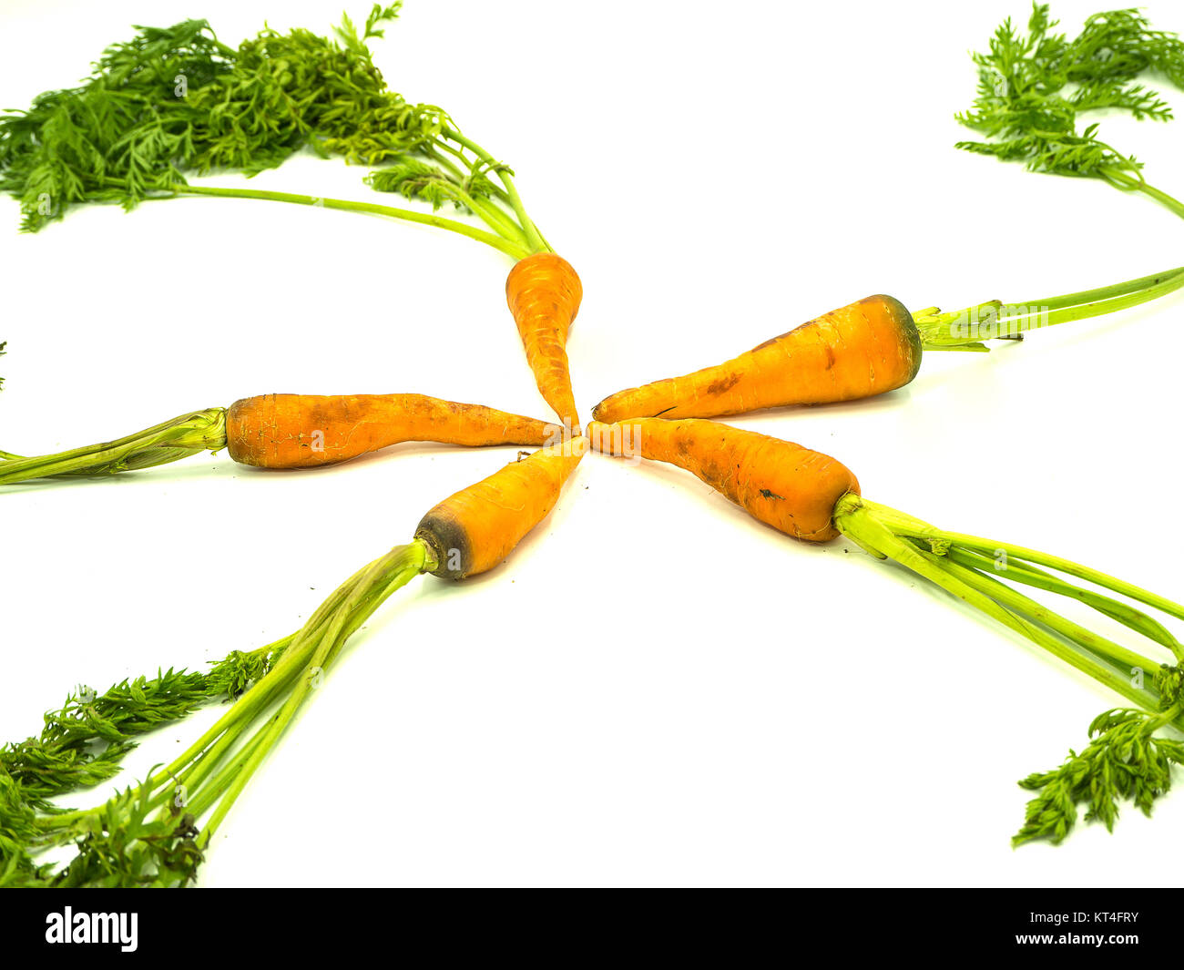 Baby carrot with leaf on isolated white background, star Stock Photo