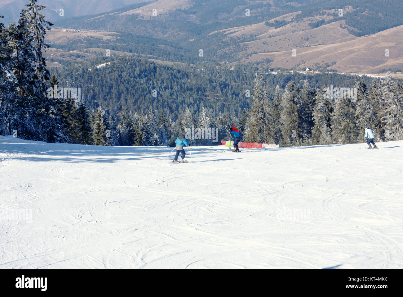 Skier riding on fresh snow go down the ski resort in the mountains at