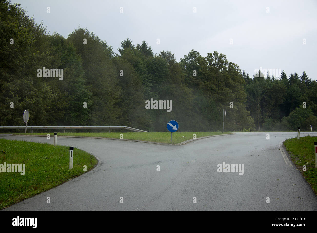 Kreuzung mit Richtungspfeil nach Regen in der Steiermark im Sommer Stock Photo