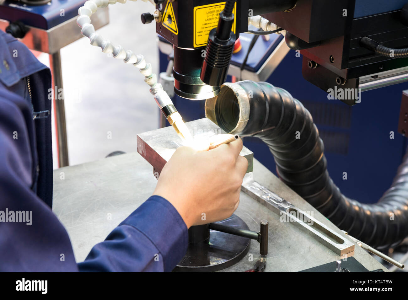 The operator use the laser welding machine.The hi-precision welding process . Stock Photo