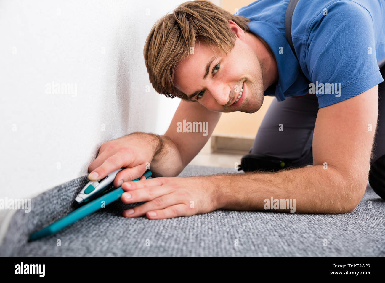 Craftsman Cutting Carpet With Cutter Stock Photo Alamy