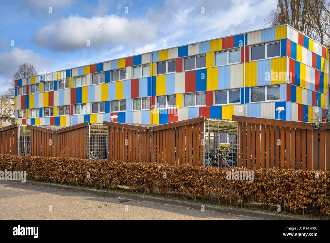 Student housing in shipping containers painted in pright colors with bicycle parking in the foreground Stock Photo