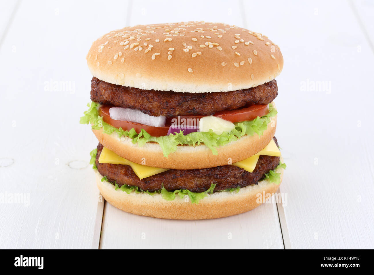 doubleburger double burger hamburger cheese tomato salad wooden board Stock Photo