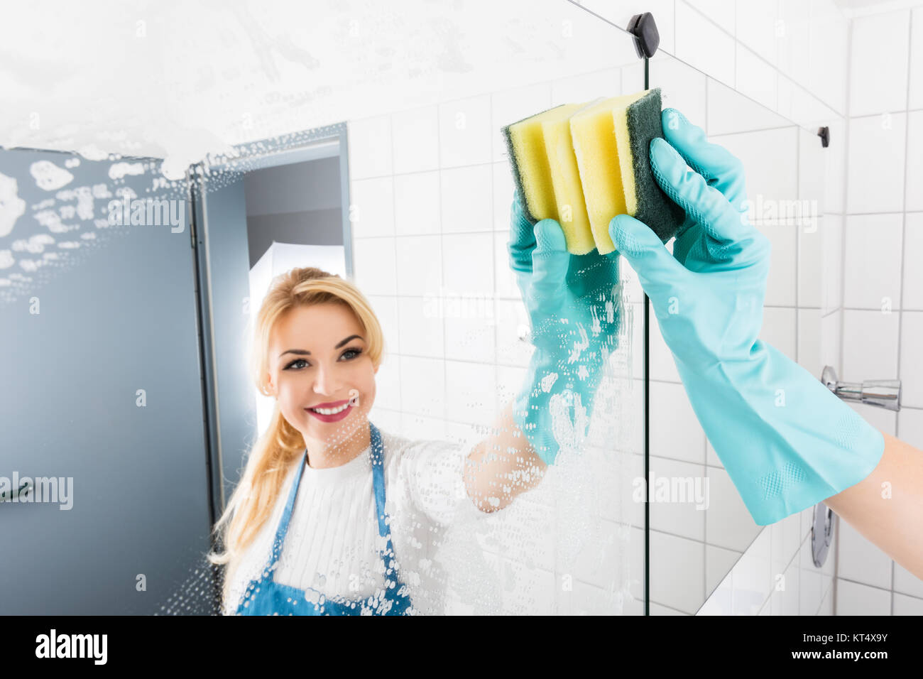 Female Janitor Cleaning Bathroom Mirror Stock Photo Alamy