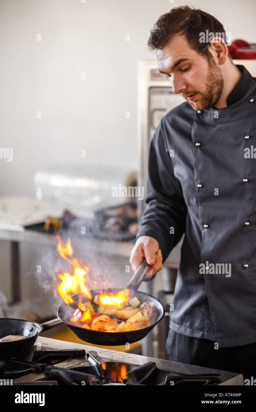 Chef is stirring vegetables Stock Photo